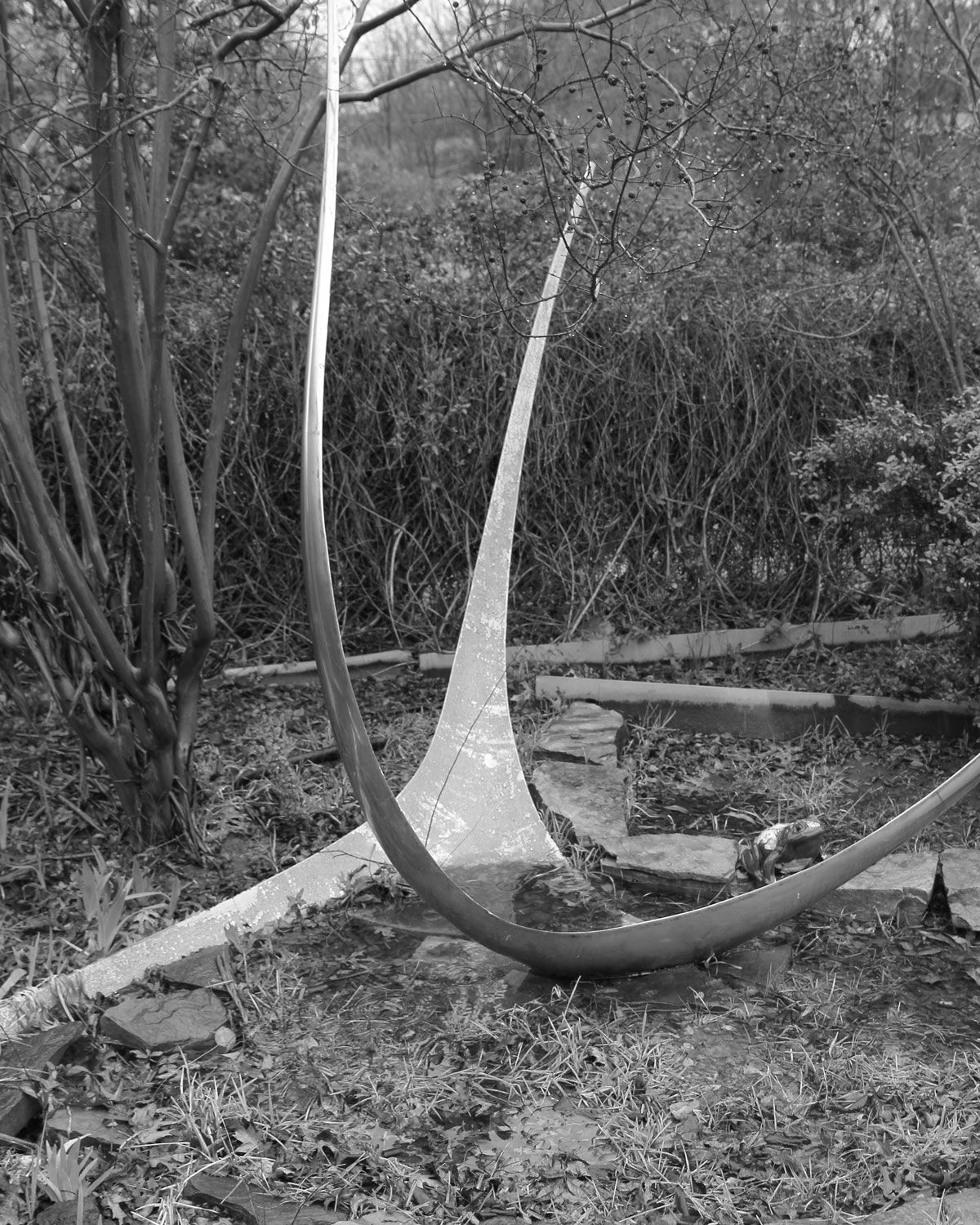 The Wishing Star sculpture as found in 2015 — weathered and standing in an overgrown backyard garden